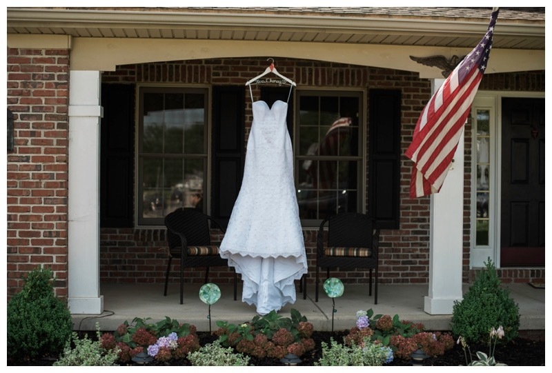 Beautiful wedding gown hung in front of the Bride's family home.